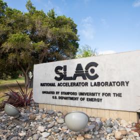 The sign that denotes the main entrance to SLAC National Accelerator Laboratory, located at 2575 Sand Hill Road in Menlo Park, California.
