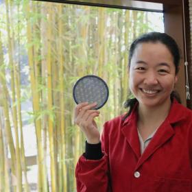 Photo of Stanford researcher Fang Liu holding a model of moire materials