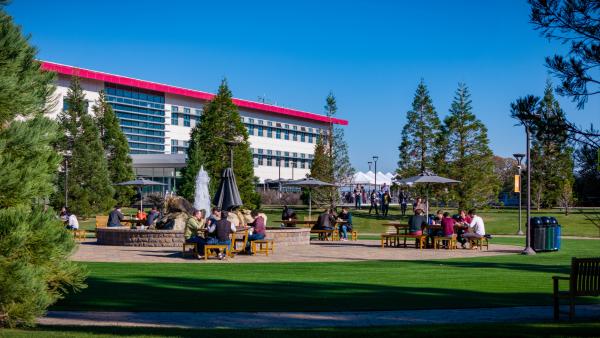 Staff members at SLAC having lunch on the main quad outside the Science and User Support Building