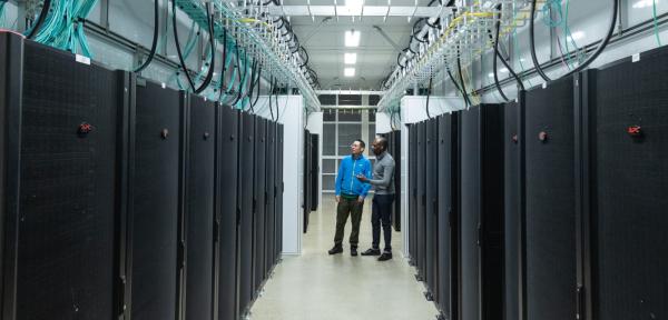 People standing inside a computing facility